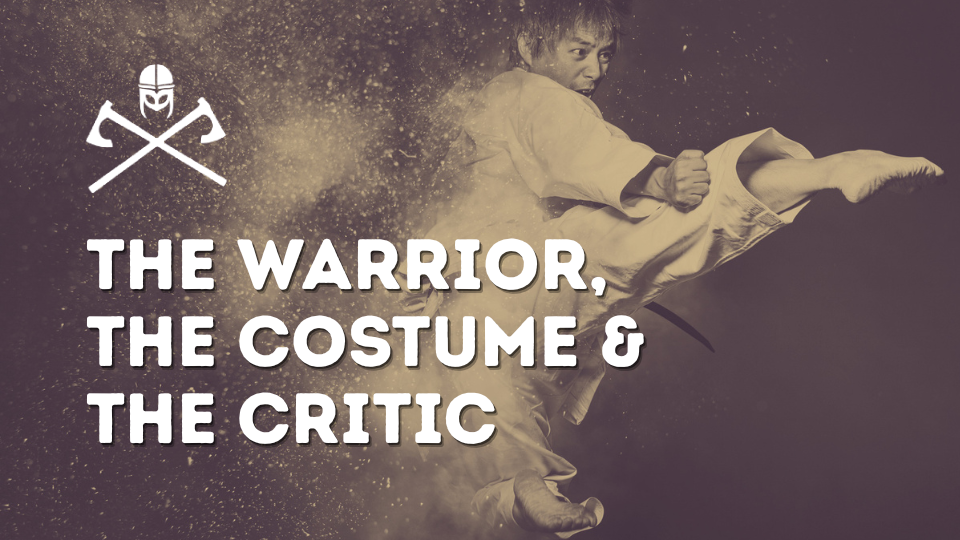 Poster of a martial artist delivering a kick with bold white text: 'The Warrior, The Costume & The Critic' and a helmet with crossed axes logo on the left.